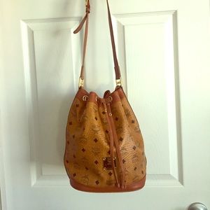 MCM bucket bag with drawstring closure.